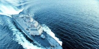 Military ship moving fast on the ocean