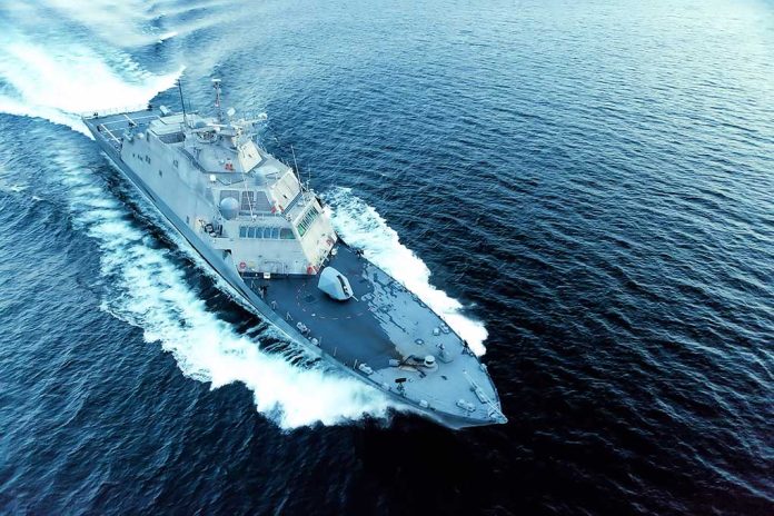 Military ship moving fast on the ocean