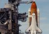 Space shuttle on launch pad with support structure
