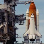 Space shuttle on launch pad with support structure