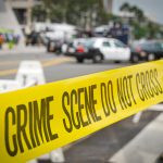 Yellow crime scene tape at urban street location