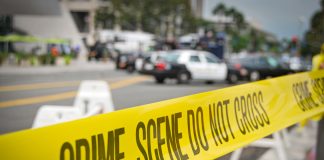 Yellow crime scene tape at urban street location