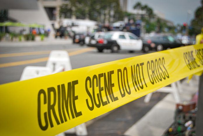 Yellow crime scene tape at urban street location