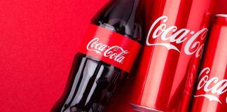 Coca Cola bottles and cans on red background