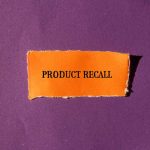 Product Recall text on orange paper, purple background