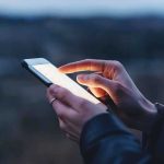 Person using a smartphone at dusk
