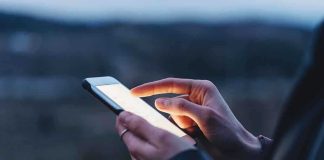 Person using a smartphone at dusk