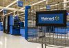Walmart shopping cart inside store near checkout aisl