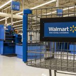 Walmart shopping cart inside store near checkout aisl
