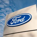 Ford logo sign against blue sky