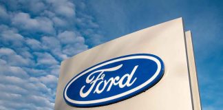 Ford logo sign against blue sky