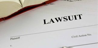 Lawsuit document with a pen and book