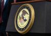 Department of Justice seal on a podium