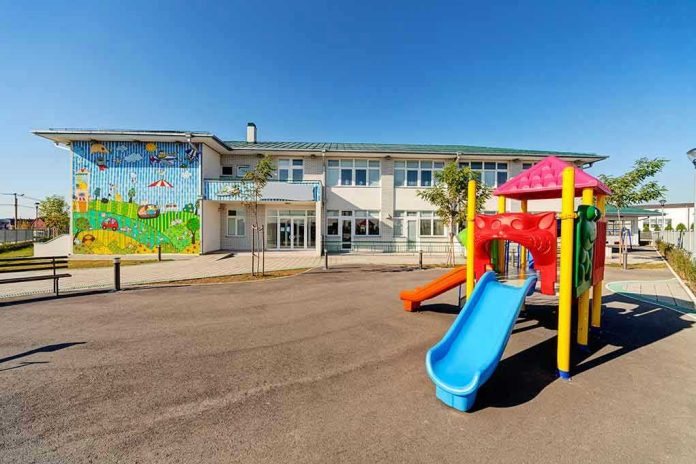 20485255 Colorful playground slide in front of a building