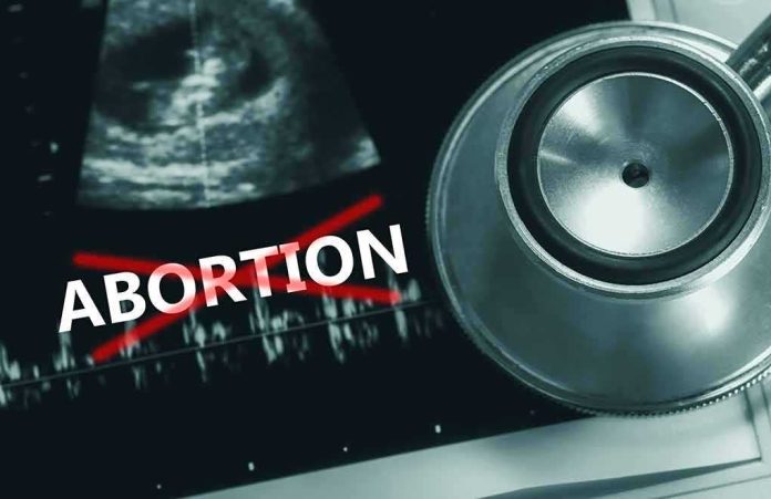 2171348999 featured image Ultrasound stethoscope and ABORTION crossed out in red