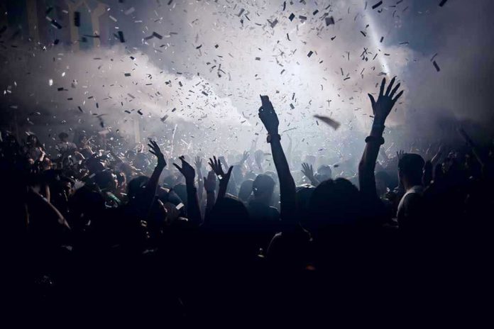 420455902 Crowd celebrating under confetti and bright lights