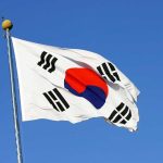 South Korean flag waving against a clear blue sky