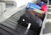 Various suitcases on an airport luggage carousel