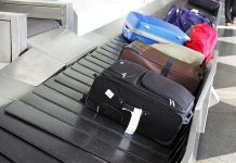 Various suitcases on an airport luggage carousel