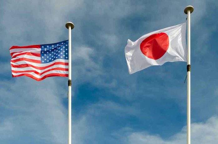 USA and Japan flags flying on flagpoles