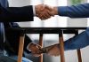 Handshake and exchange of money under the table