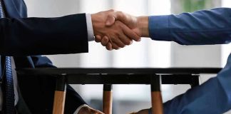 Handshake and exchange of money under the table