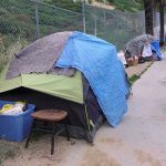 Tents and belongings set up along sidewalk