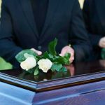 Outrage Erupts: Father Admits to Killing Crying Infant People placing white roses on a casket
