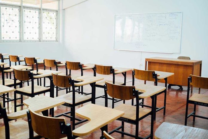 Empty classroom with desks, chairs, and whiteboard.