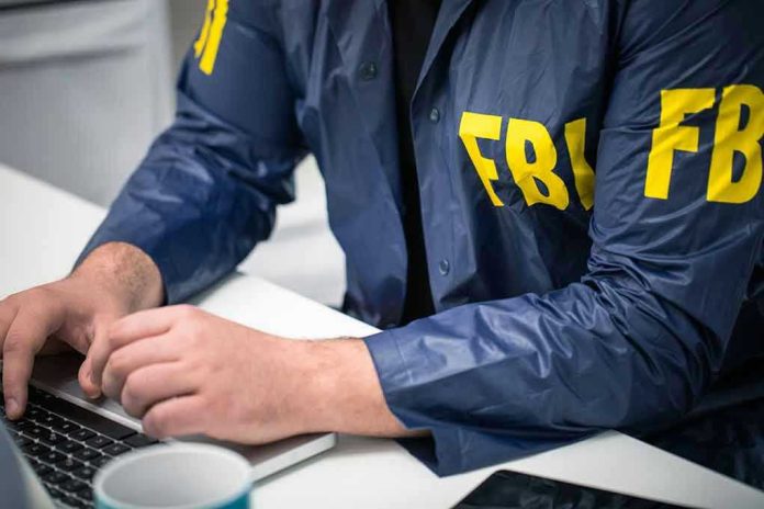 629482379 Person in FBI jacket typing on a laptop