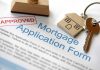 Approved mortgage application form with a house key and keychain