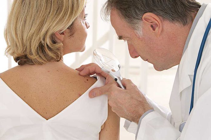 Doctor examining a patient's skin with a magnifying glass