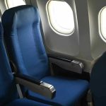 Empty airplane seats next to windows