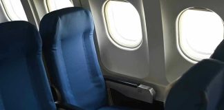 Empty airplane seats next to windows