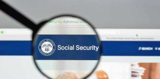 Magnifying glass focusing on Social Security Administration webpage.