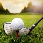 Golf Courses Double Parkinson’s Risk — Alarming Discovery A golf ball on a tee with a golf club resting beside it on green grass