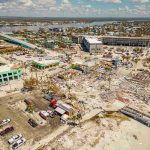 Aerial view of hurricane-damaged buildings and debris.
