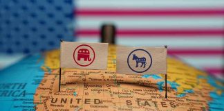 Republican and Democratic flags on USA map background.