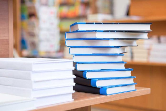 A stack of neatly arranged books on a wooden table in a bookstore