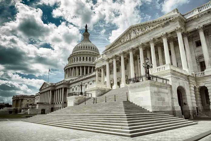 Capitol building with columns and cloudy sky.