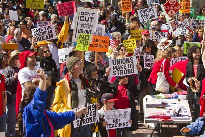 Crowd of protesters holding signs advocating for labor rights and social justice
