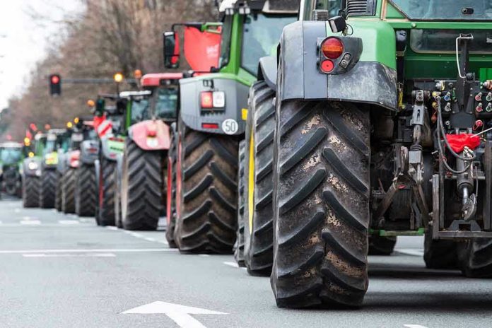 Tractors lined up on a city street.
