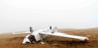 Crashed airplane lying on its side in a foggy field