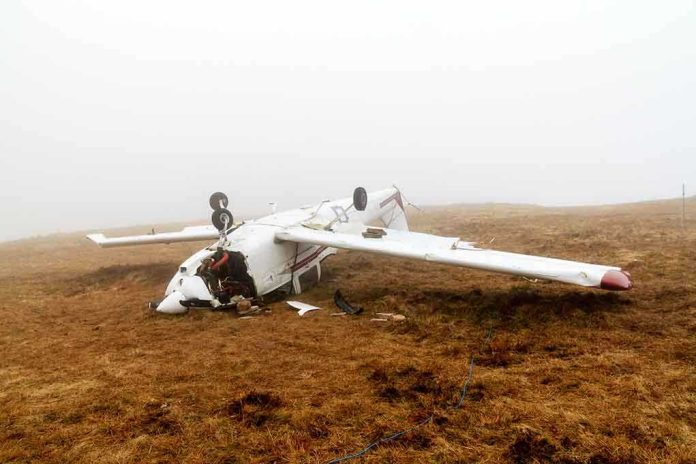 Crashed airplane lying on its side in a foggy field