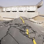 Severely damaged road and collapsed bridge due to earthquake