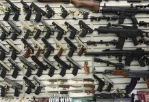 Gun Purchase Plot to Kill ICE Agents Revealed Wall display with handguns and rifles for sale.