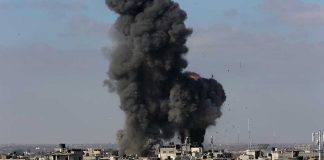 Large explosion over a crowded urban area.