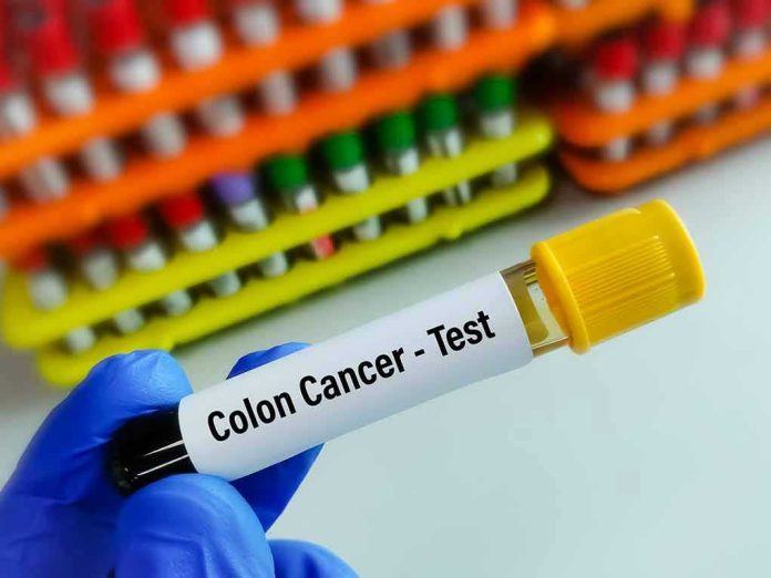 227507861 Gloved hand holding colon cancer test tube