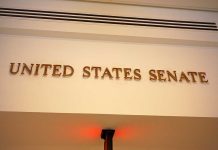 Senate Unanimously CRUSHES Deepfake Terror Sign displaying United States Senate in a government building