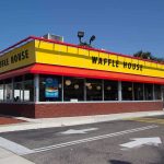 Exterior view of a Waffle House restaurant with bright yellow signage